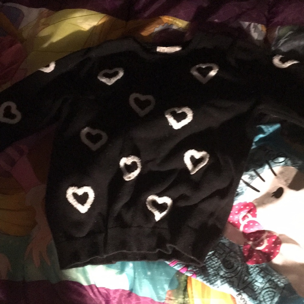 A black sweater with mini white hearts